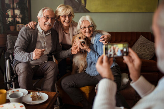 Group of seniors with dog taking a photo together