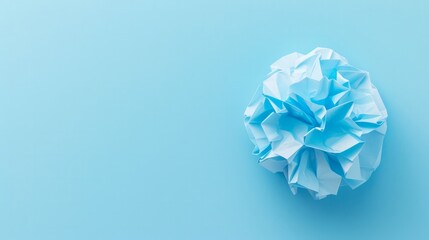 Paper ball on clear light blue background 