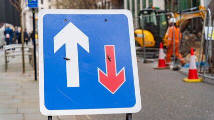 Traffic priority directional arrows on a sign in London