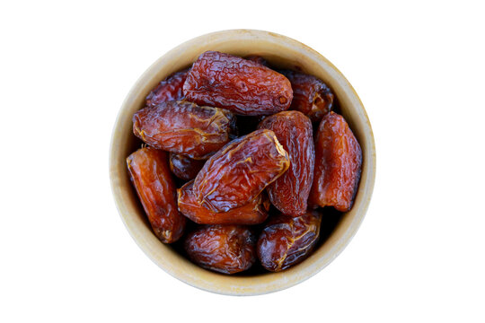 Dried dates in a bowl isolated on a transparent background.