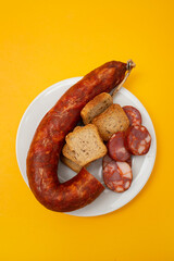 typical portuguese smoked sausage chourico on white plate