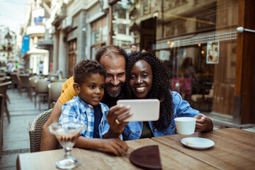 Family Taking a Selfie at a Cafe Terrace
