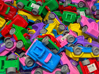 Colorful plastic toy trucks piled together