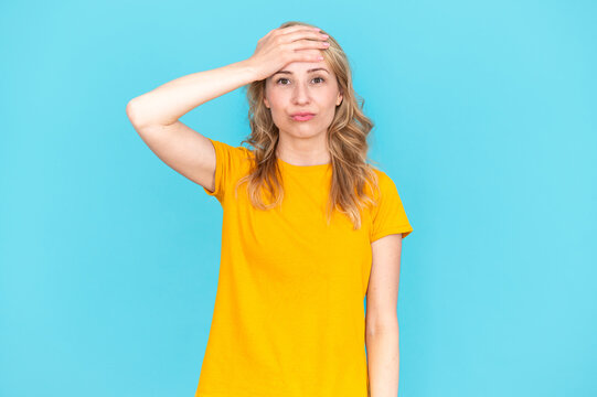 Portrait of woman holding forehead and forgot something important
