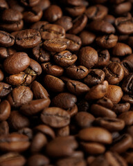 coffee beans are on table after roasting. Fresh converted coffee beans before packing in paper bag. Ground coffee for making Americano or cappuccino. grain cultivation and harvesting