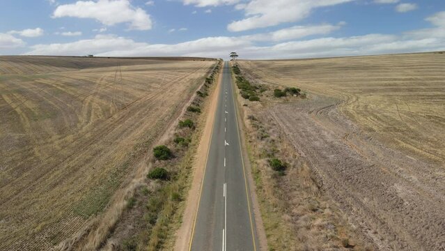 Road to Arniston at straight and long asphalt roads and white cars moving with a view from top