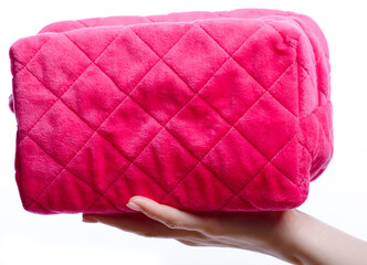 Pink cosmetic bag in hand make up beauty on white background isolation