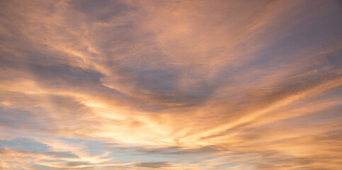 Naklejka na ściany i meble shiny sky background at sunset with yellow and grey clouds