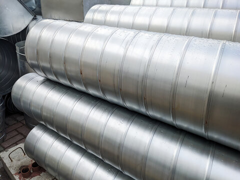 Piles of metallic pipes neatly stacked in a warehouse. Infrastructure Details