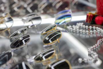Various sunglasses on a glass shop window