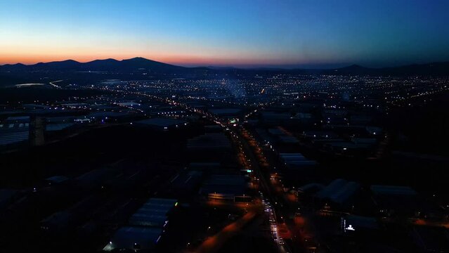 Aerial View of Factories with Evening Traffic on City Roads
