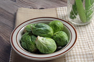 Fresh Brussels sprouts in a bowl, ready to cook.