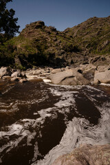 View of Yuspe river in the rock massif Los Gigantes in Cordoba, Argentina. View of the water flowing across the rocky hills.	
