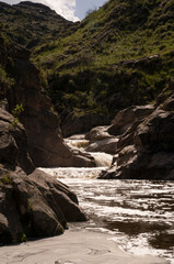 View of the river Yuspe in The Giants natural reserve in Cordoba, Argentina. View of the water flowing across the rocks and forest.