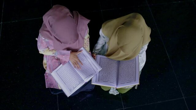 Two moslem women reading the Koran