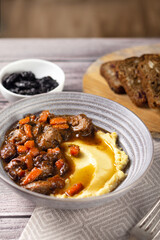Meat with prunes, goulash and mashed potatoes vertical tasty
