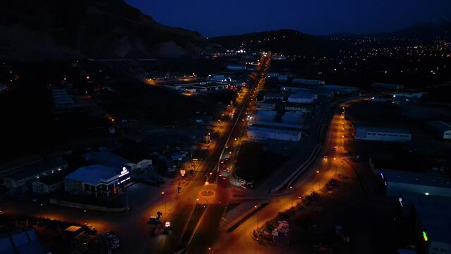 Aerial View of Factories with Evening Traffic on City Roads