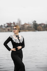 Middle age lady in classical vintage black long dress with white lace around neck, nice collar...