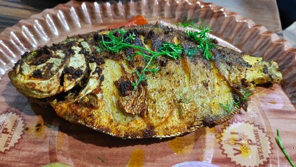 Tasty fish fry with Indian spices served on table