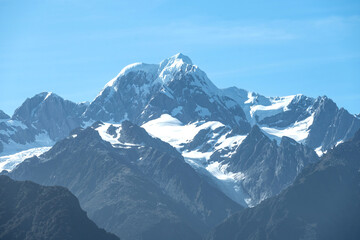 The view of Mt. Tasman peak, one of the famous landmark, near Mt. Cook in a fresh sunny day under blue sky, West Coast, New Zealand.