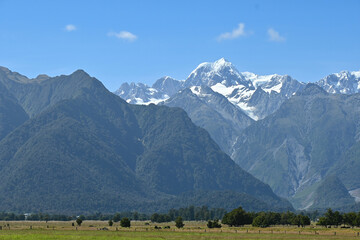 The view of Mt. Tasman near Mt. Cook from afar in a fresh sunny day under blue sky, West Coast, New Zealand.