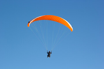 Paragliding. Paragliding in Auvergne. paragliding flight in the mountains in France. Paragliding over the clouds. Sea of clouds and paraglider. Panorama of the mountains. Puy de Dôme. Parapente.