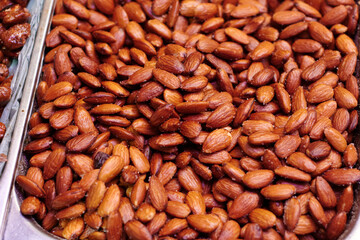 Salted and roasted almond skin. Tasty smoked nuts.