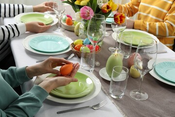 Festive table setting. Women celebrating Easter at home, closeup