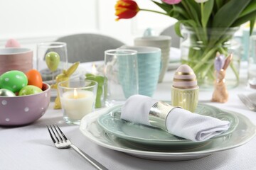 Easter celebration. Festive table setting with painted eggs.