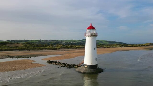 Pull-out drone shot of Point of Ayr Lighthouse on the north coast of Wales, on the Point of Ayr, UK