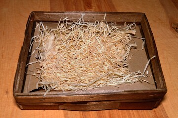 On table basket with sawdust hay used to secure the shipment of delicate items