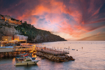 Sorrento, Italy. Breathtaking view after sunset of Marina Grande with seaside restaurants, fishing...