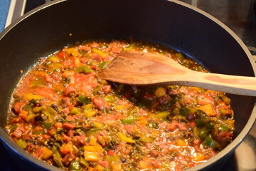 frying vegetables with cut salami