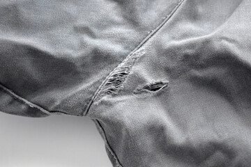 Broken jeans on the back cracked with hole at the crotch. Sewing machine and stitching repair...
