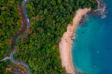 Top view road seaside during sunset. Coconut trees and paradise sea landmark in Phuket, Thailand. Concept car driving tropical beach trips holiday