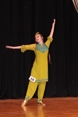 Woman dancing traditional ethnic persian tajik dance on the stage in dancing costume	