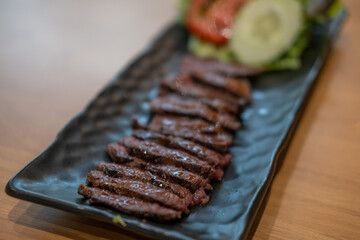 Medium rare meat served on plate with vegetable