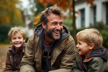 Man Sitting Next to Two Small Boys