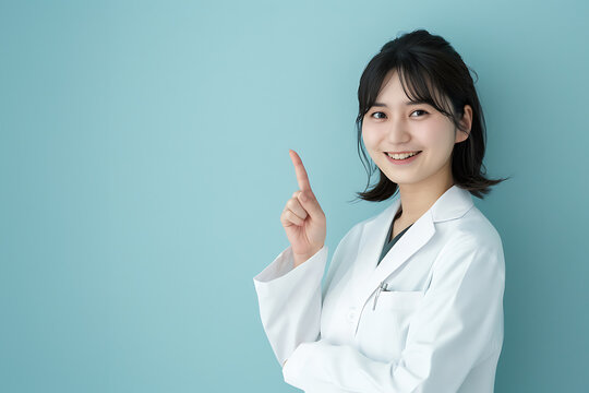 Smiling asian woman doctor showing a finger to the camera