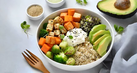 Poster salad with avocado and cheese . Buddha bowl with quinoa, tofu, avocado, sweet potato, brussels sprouts and tahini dressing © Sadaf