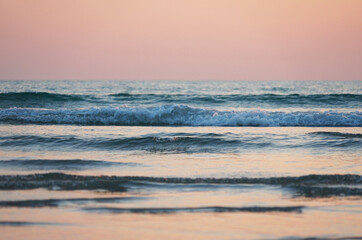 Fototapeta premium Beach and waves at sunset