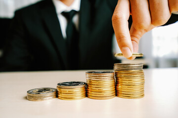 Businessman working with coin money currency. Concept of investment growth and money saving. uds
