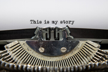 A close up of an old fashioned typewriter that has printed out the words This is my story