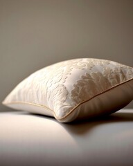 White Pillow with Floral Pattern on a Bed
