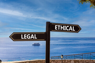 Ethical or legal symbol. Concept word Ethical or Legal on beautiful signpost with two arrows....