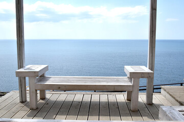 Travel and recreation. View of the blue sea from a gazebo located on a rocky shore