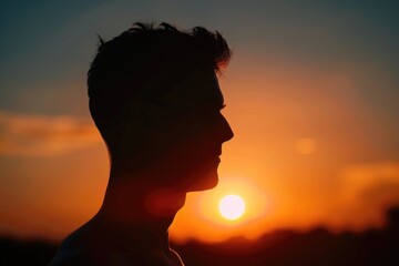 A man's silhouette against a beautiful sunset, perfect for inspirational projects