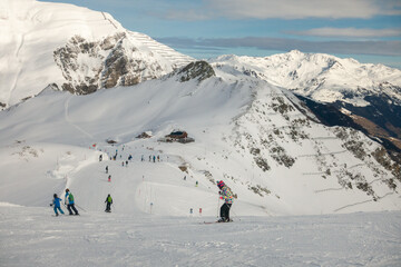 Fototapeta na wymiar Ski resort in winter Alps. Skiers ride down the slope. Tux, Hintertux, Austria.