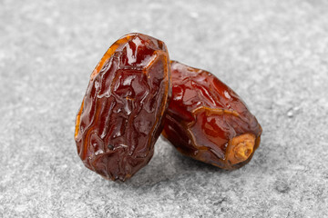 Dried delicious date fruit on vintage stone background
