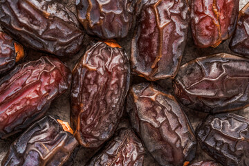 Dried delicious date fruit on vintage stone background